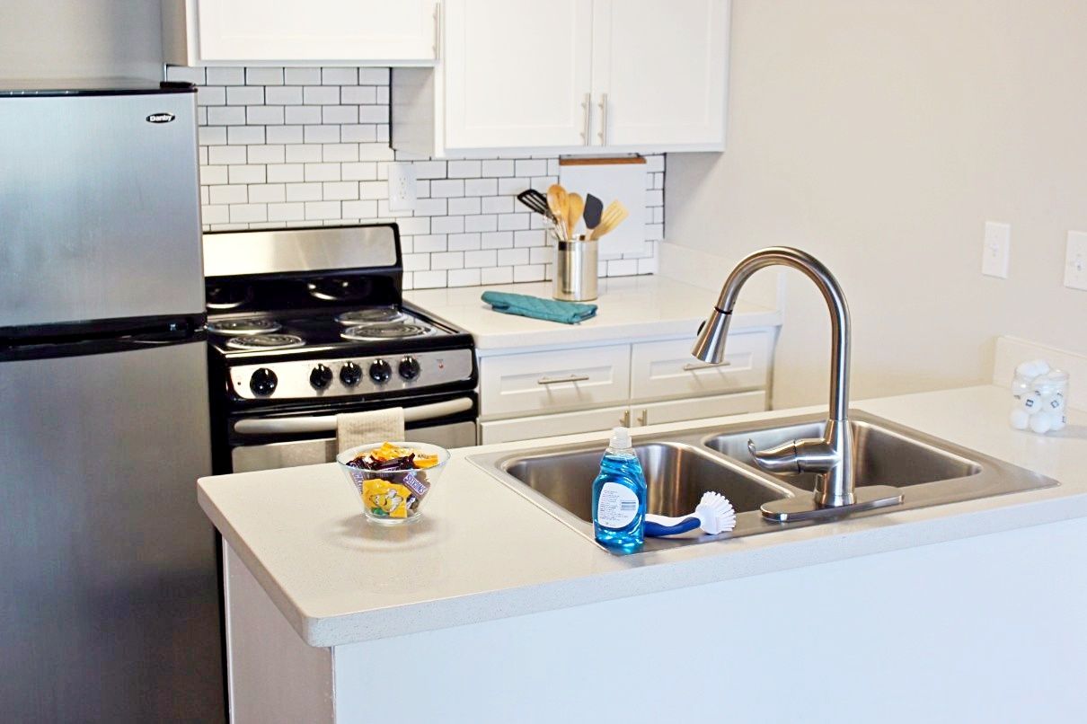 Modern apartment kitchen featuring stainless steel appliances