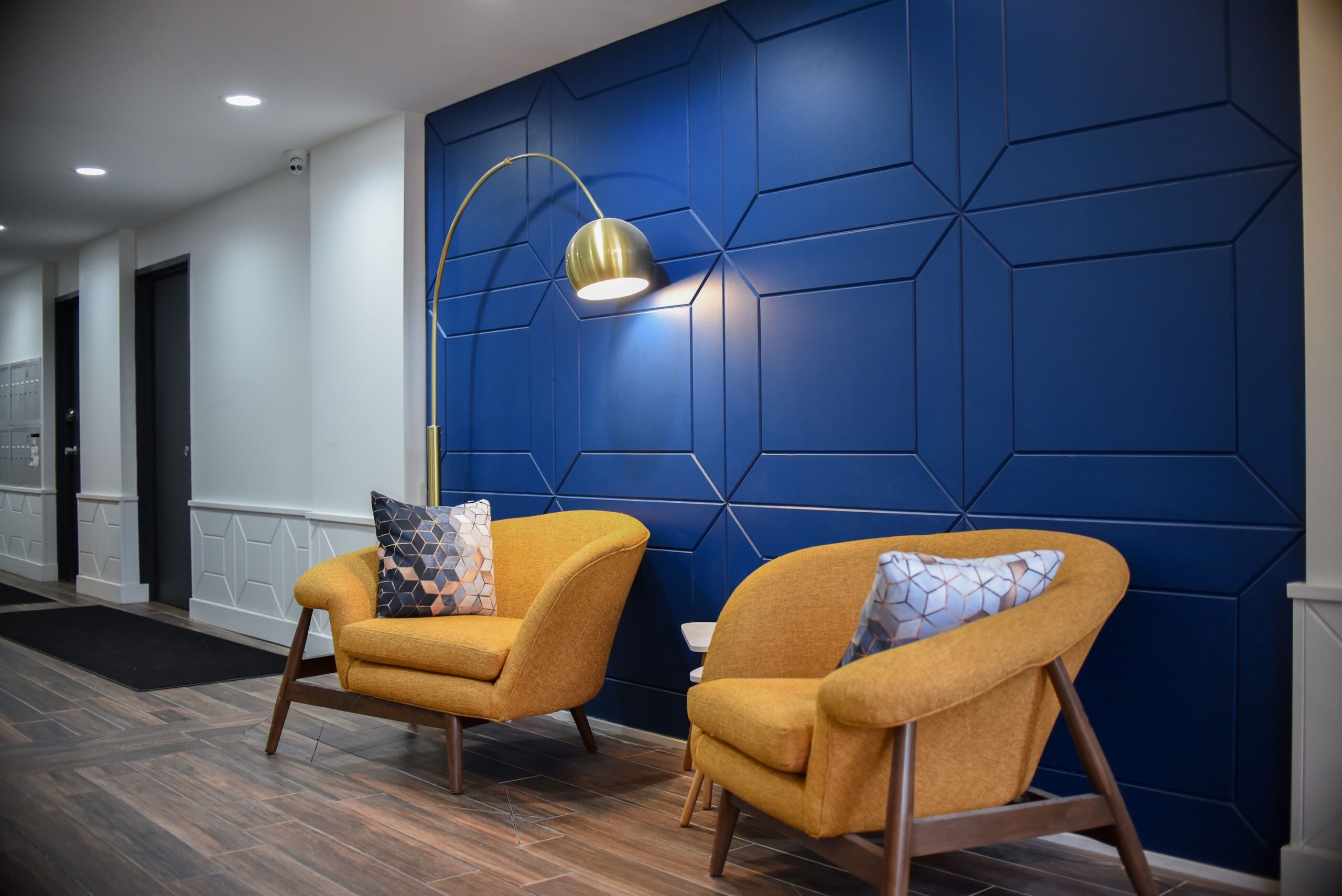 Modern building lobby seating area with yellow armchairs scaled
