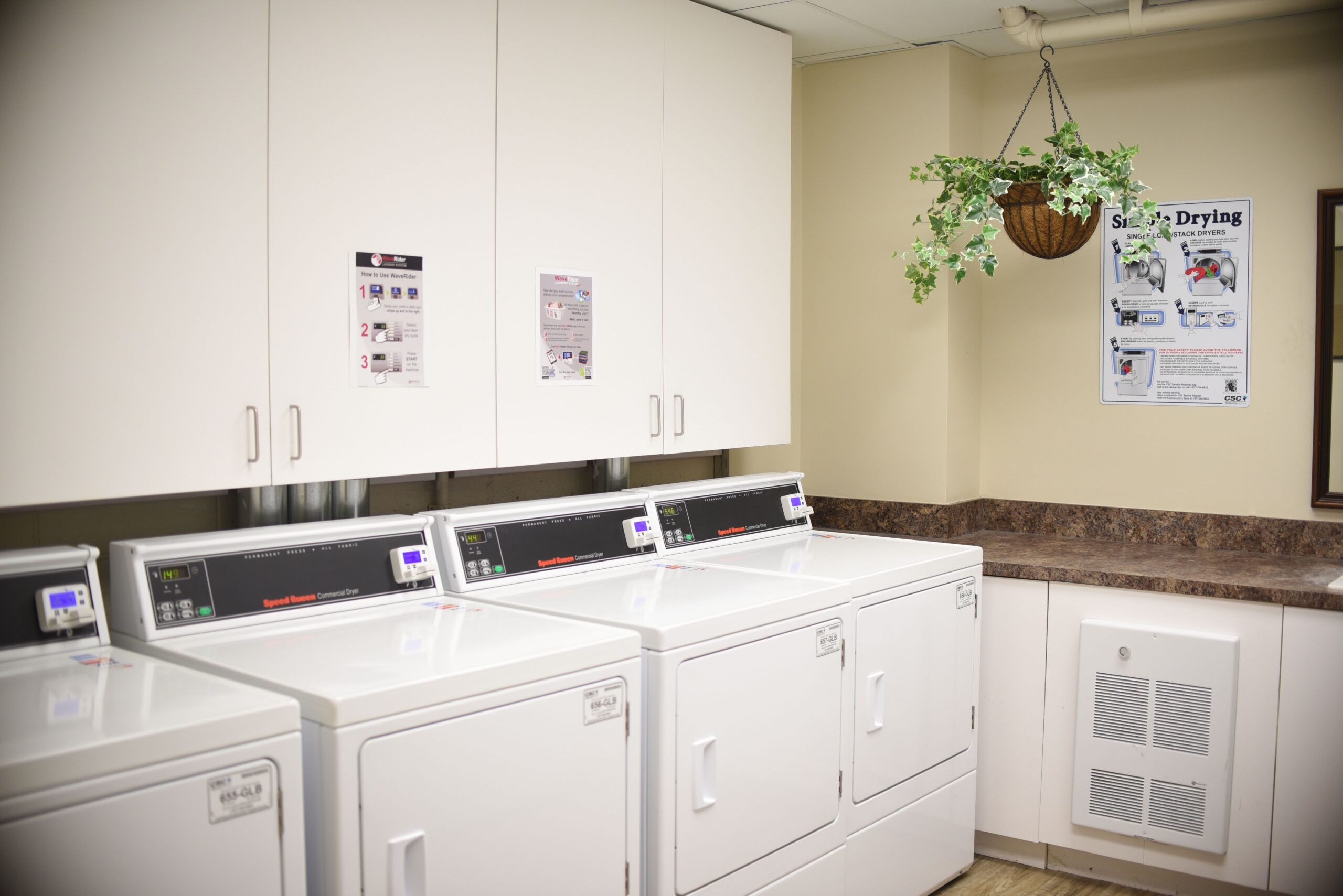 On site laundry facility equipped with commercial white washers scaled
