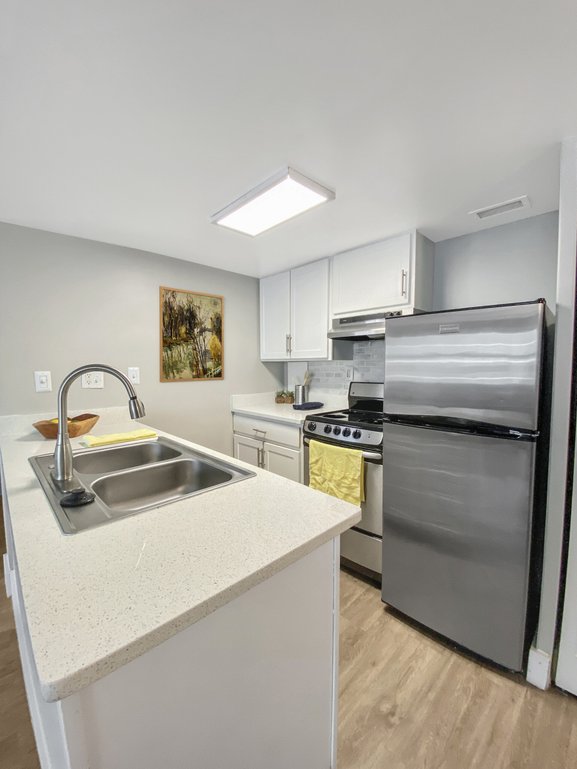 clean apartment kitchen quartz countertops stainless steel