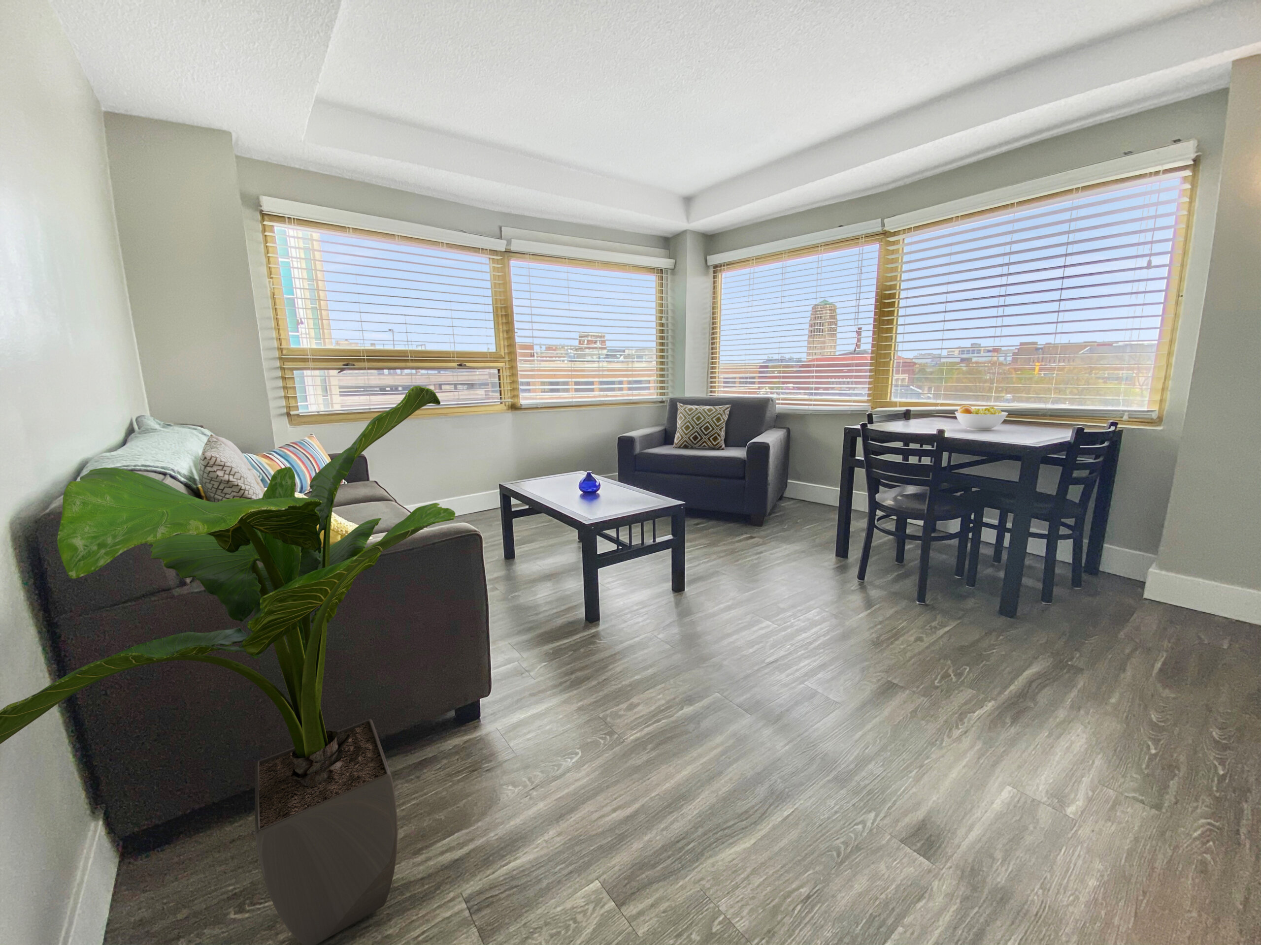 corner apartment living room wrap around windows dining table