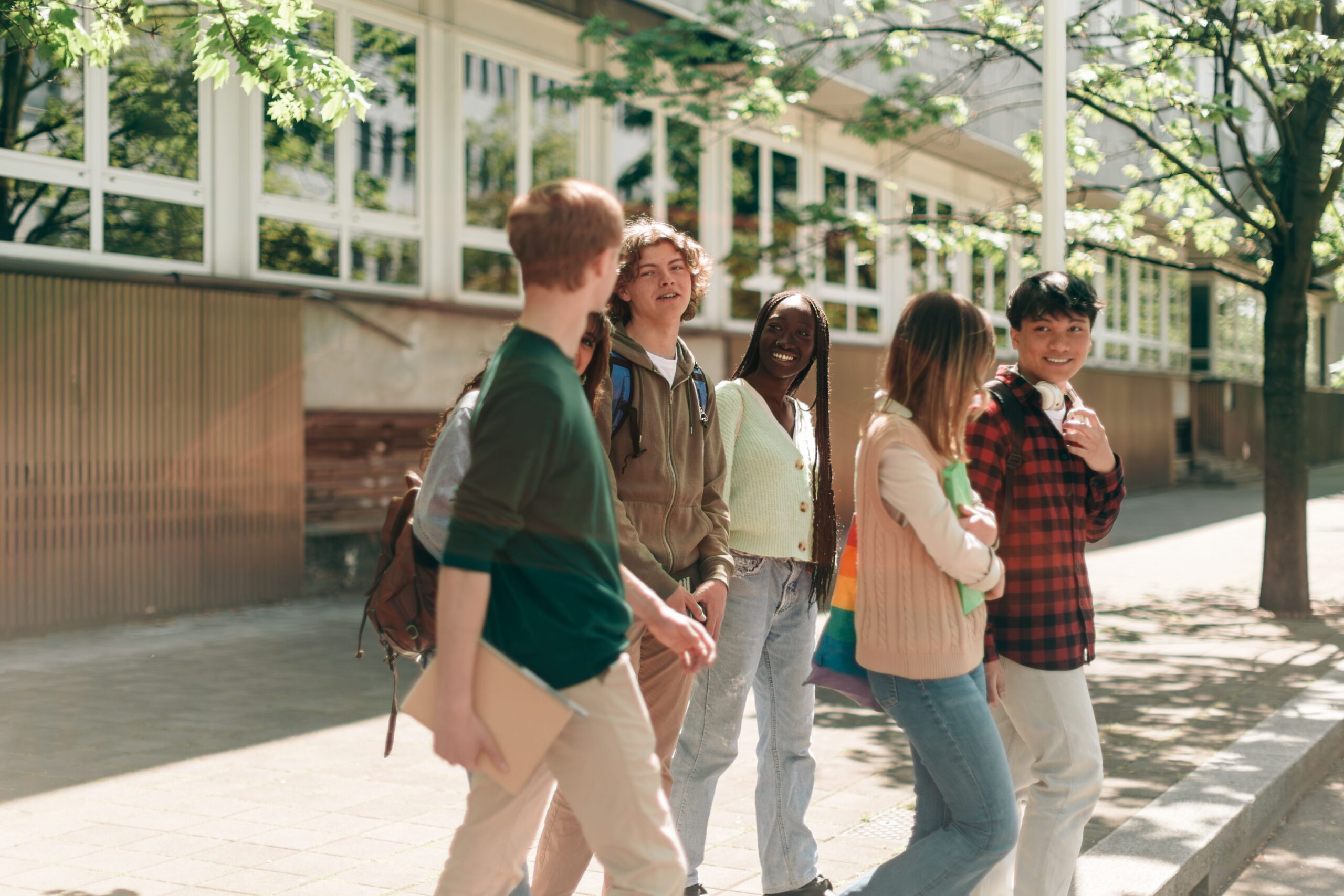 diverse students walking on university campus scaled