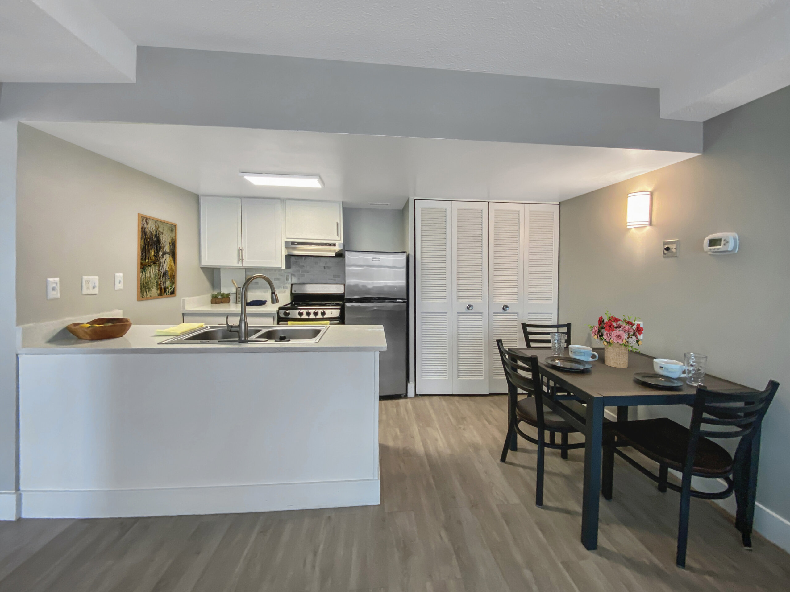 open kitchen dining area white peninsula counter