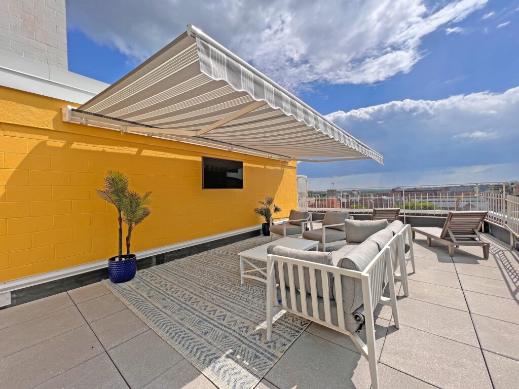 rooftop patio terrace grey lounge furniture retractable awning