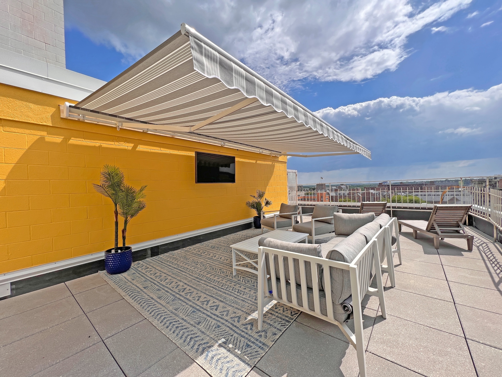 rooftop patio terrace grey lounge furniture retractable awning
