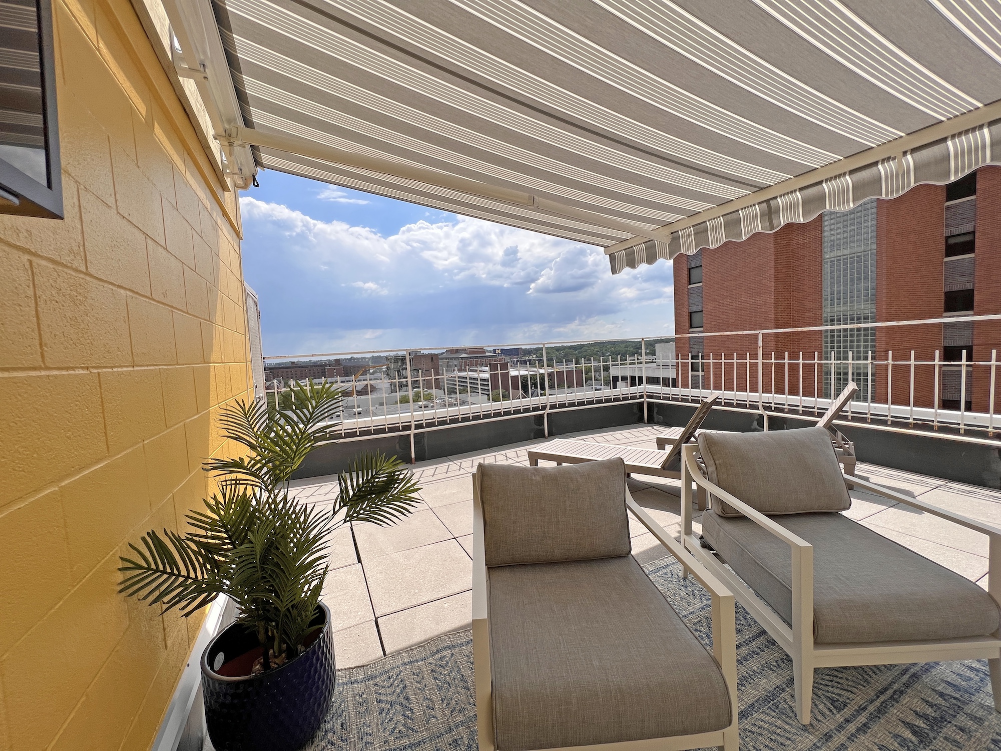 rooftop terrace lounge chairs city skyline view