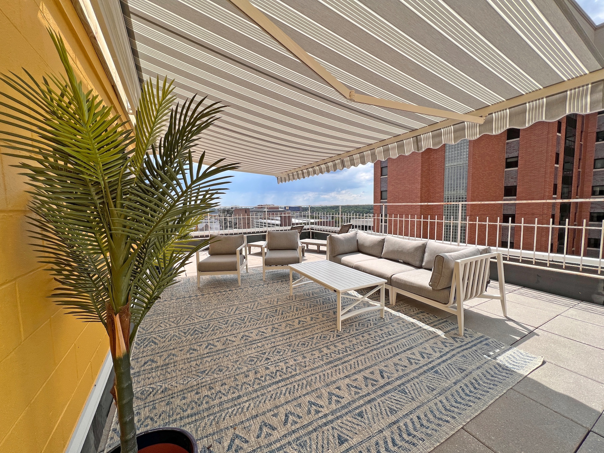 shaded rooftop lounge area outdoor sofa city views