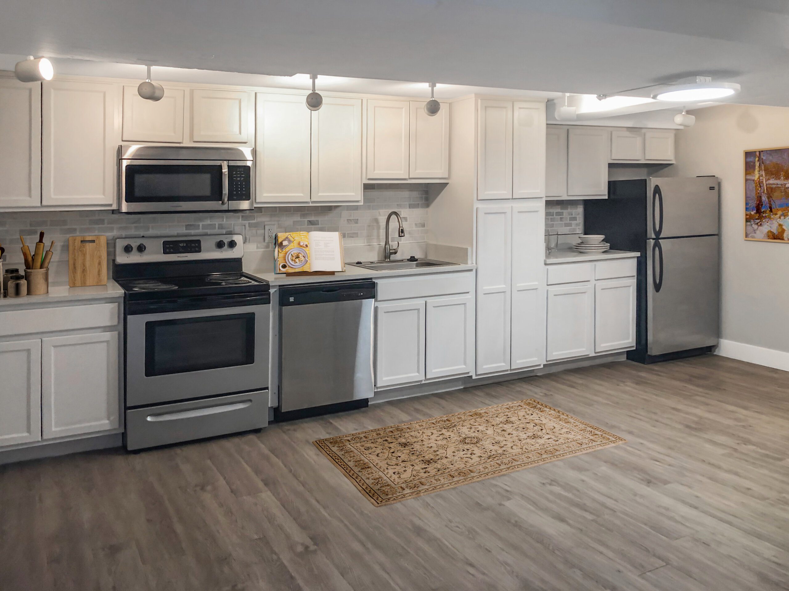 spacious townhome kitchen white cabinets stainless appliances