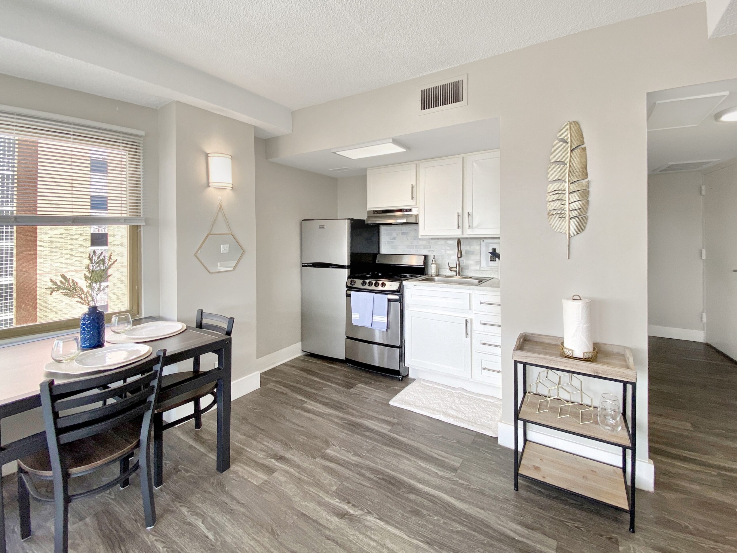 studio apartment kitchen corner stainless steel appliances scaled