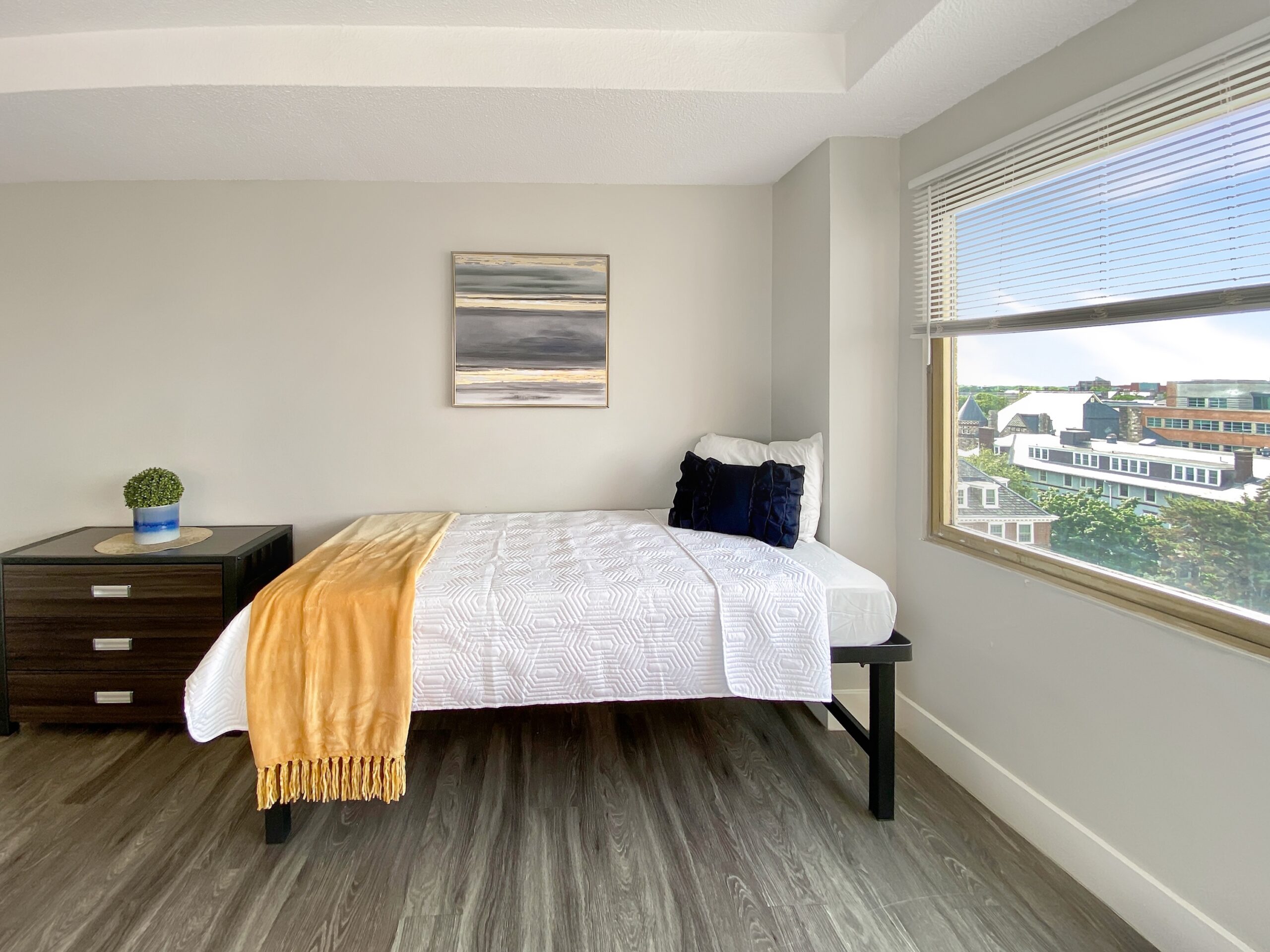 studio apartment sleeping space single bed city view scaled
