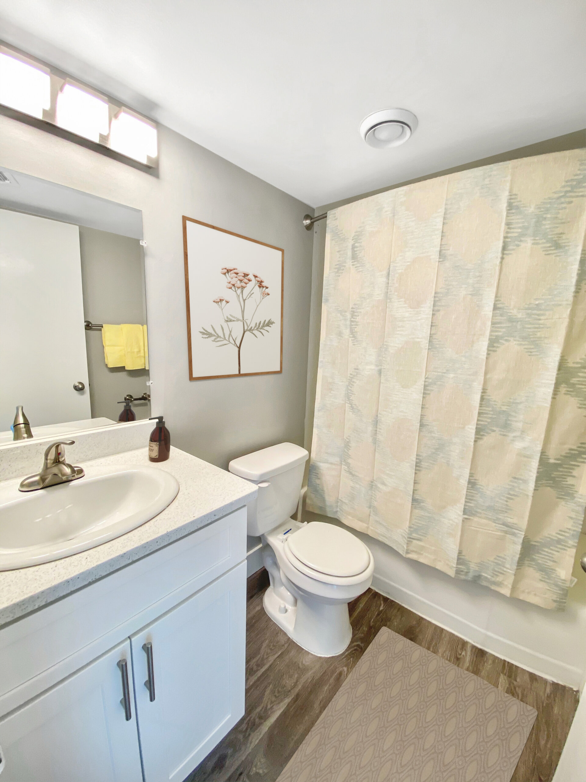 updated apartment bathroom white vanity shower curtain
