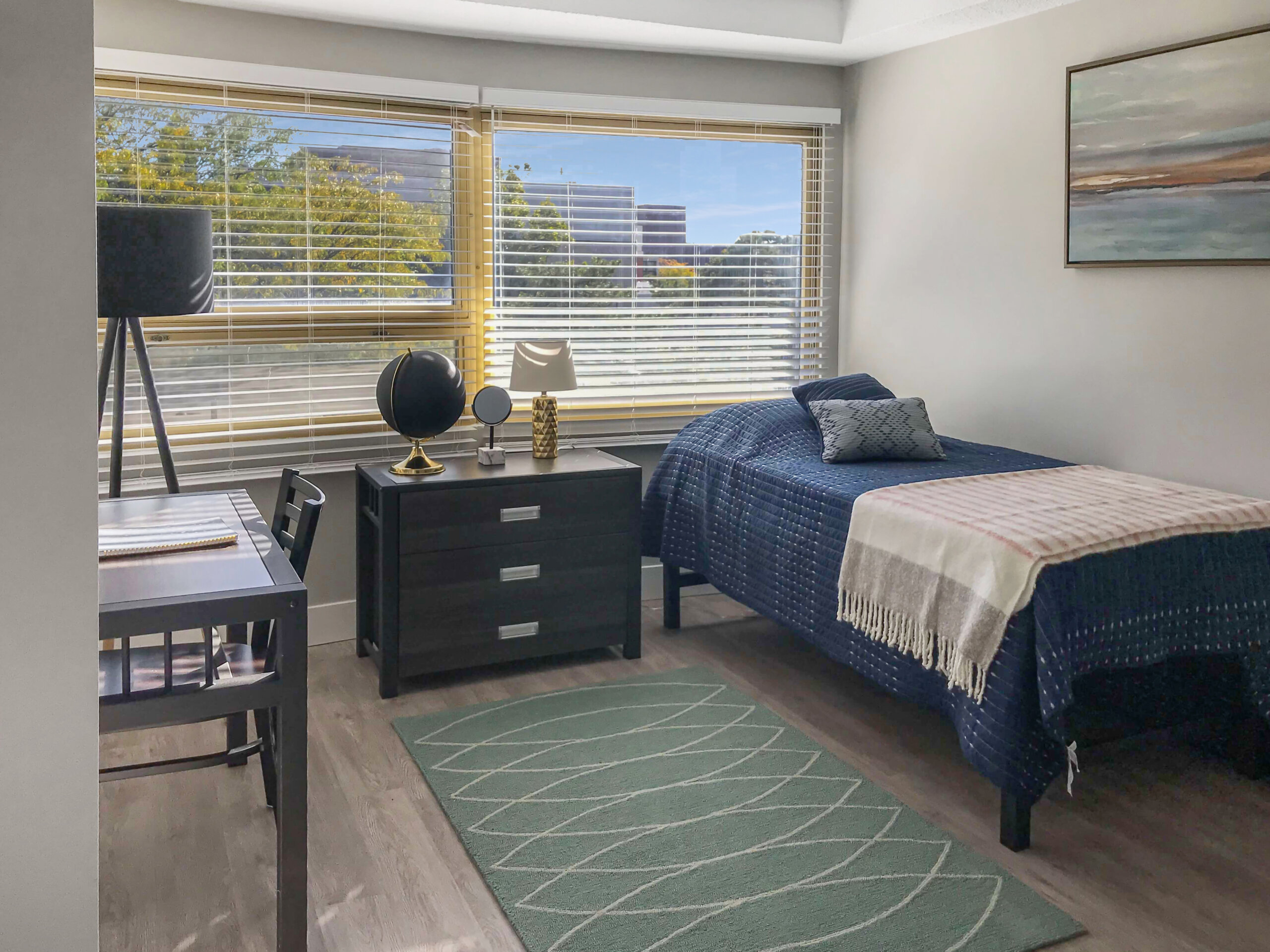 well lit bedroom navy bedding study desk
